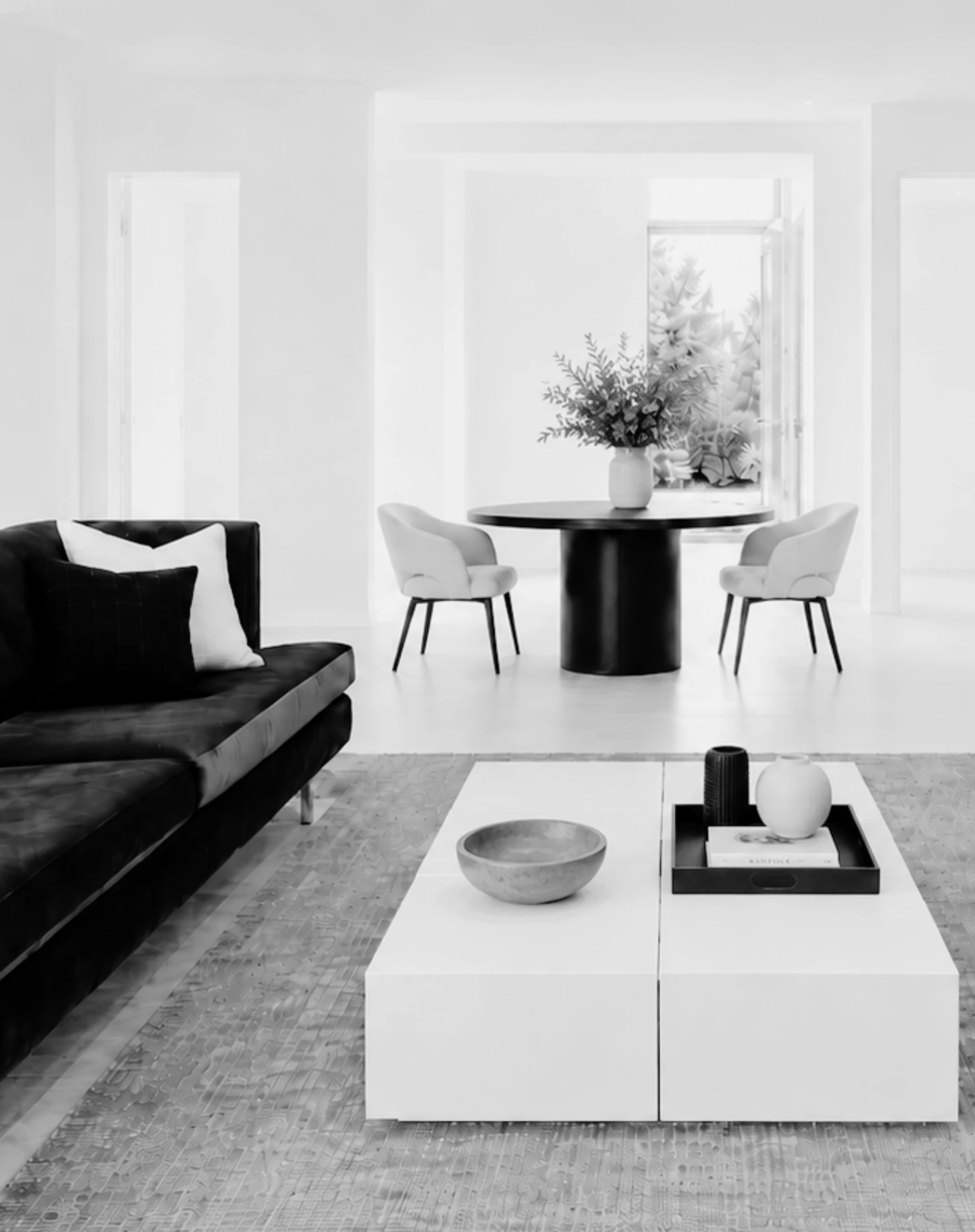 Interior of The Therapist's Den: a calm, minimal seating area in black and white